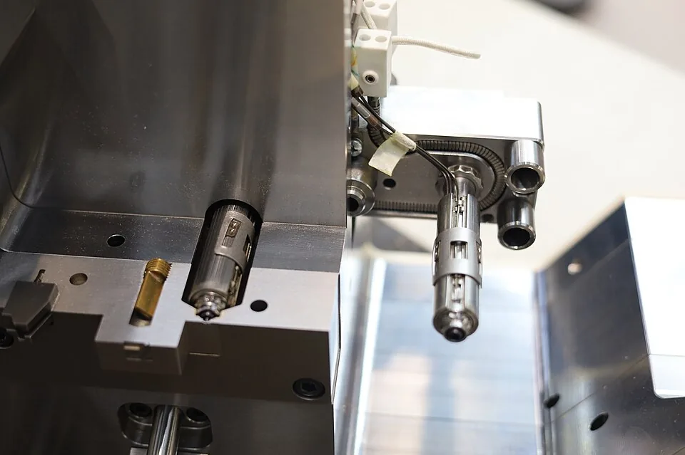 Reference photograph of an injection mold assembly showing machined steel surfaces and internal components; not Omita tooling.