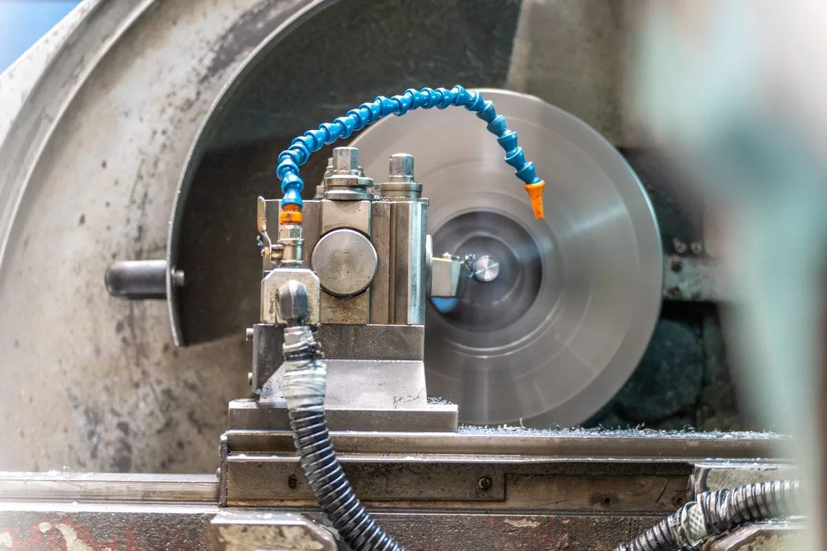 Stock photograph of a rotating workpiece and cutting tool in an industrial lathe; not Omita equipment or a customer project.